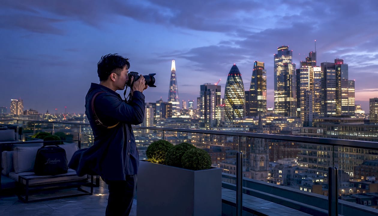 Photographer capturing London city skyline at sunset