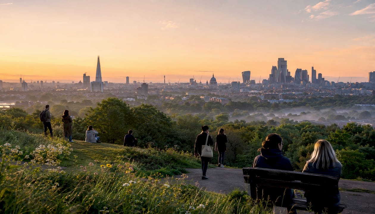 Visitors watching sunrise over London from Primrose Hill