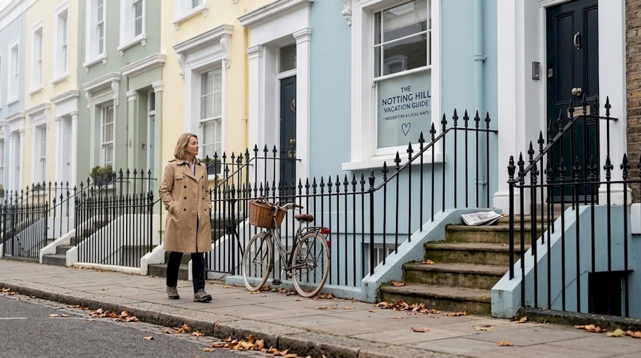 Local walking past pastel Notting Hill homes